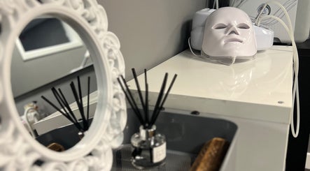 Elegant beauty setup at NKD Skin, Coatbridge, Scotland, GB with a decorative mirror and skincare device.