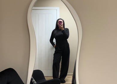 Stylish interior of NKD Skin in Coatbridge, Scotland with curvy mirror and modern decor.