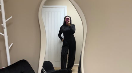 Stylish interior of NKD Skin in Coatbridge, Scotland with curvy mirror and modern decor.
