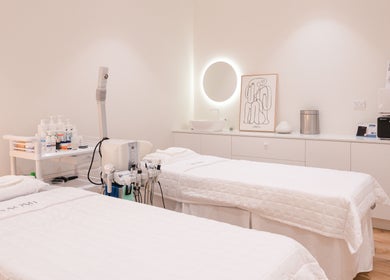 Calm treatment room at Naomi Laser and Skin Clinic, Mascot, New South Wales, AU, featuring two spa beds.