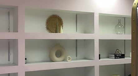 Stylish decorative shelving at Melanin Lash Bar SA in Sandton, Gauteng, ZA showcasing modern decor accents.
