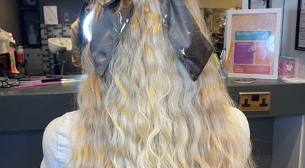 Back view of elegantly styled wavy blonde hair with a bow at MKM.hair, Perth, Scotland, GB.