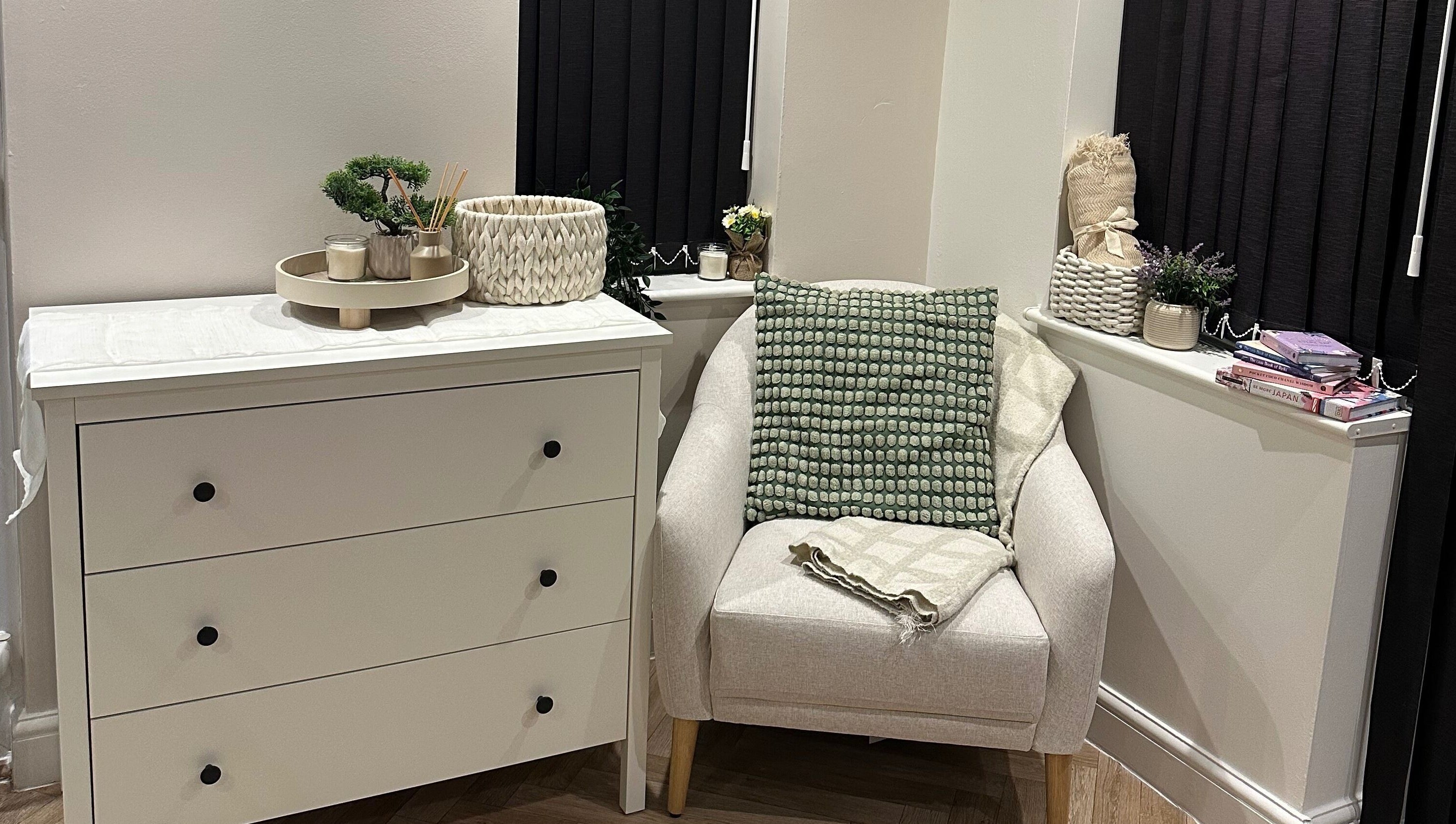Elegant white dresser and cozy chair at Venus Studios, Kirkby In Ashfield, England, GB.