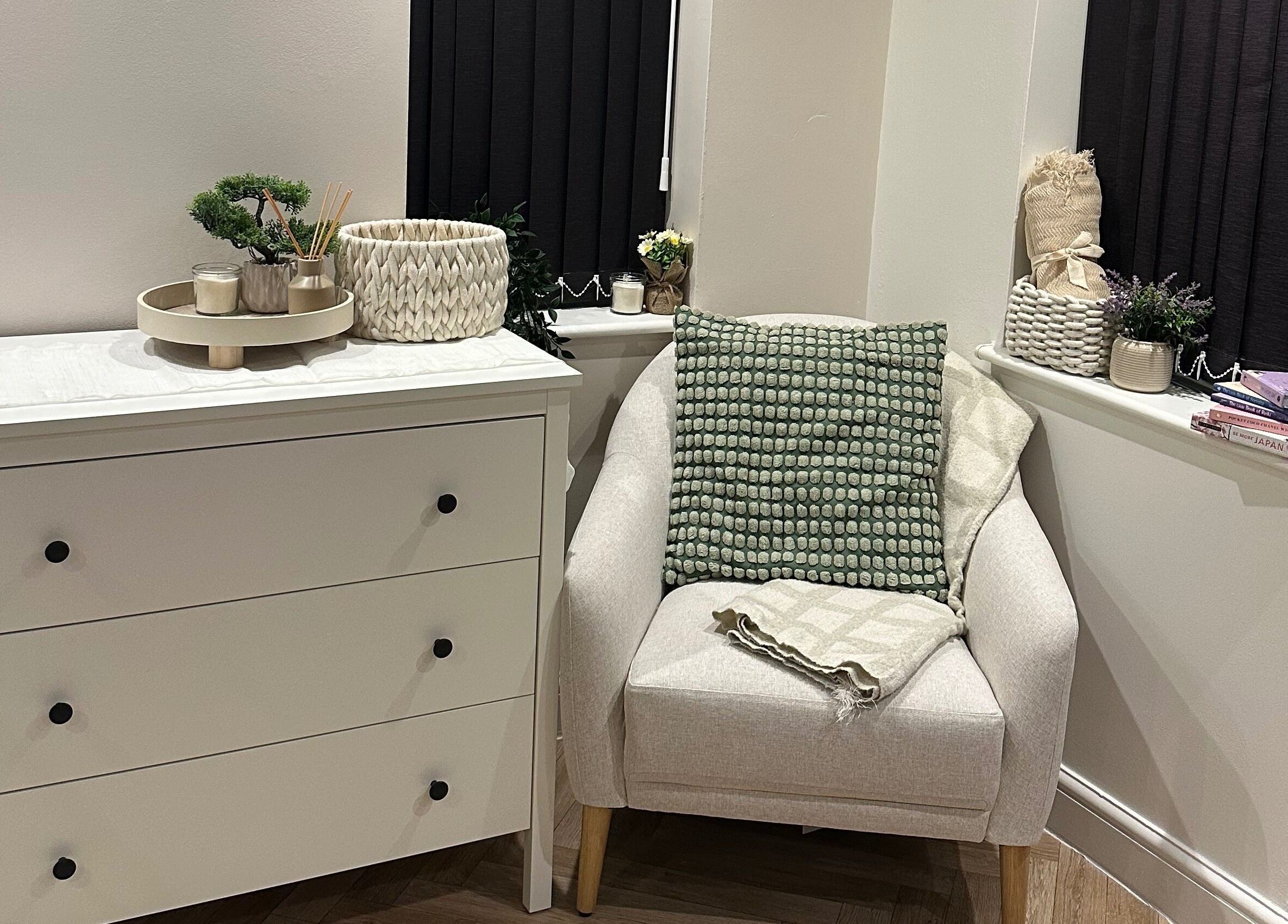 Elegant white dresser and cozy chair at Venus Studios, Kirkby In Ashfield, England, GB.