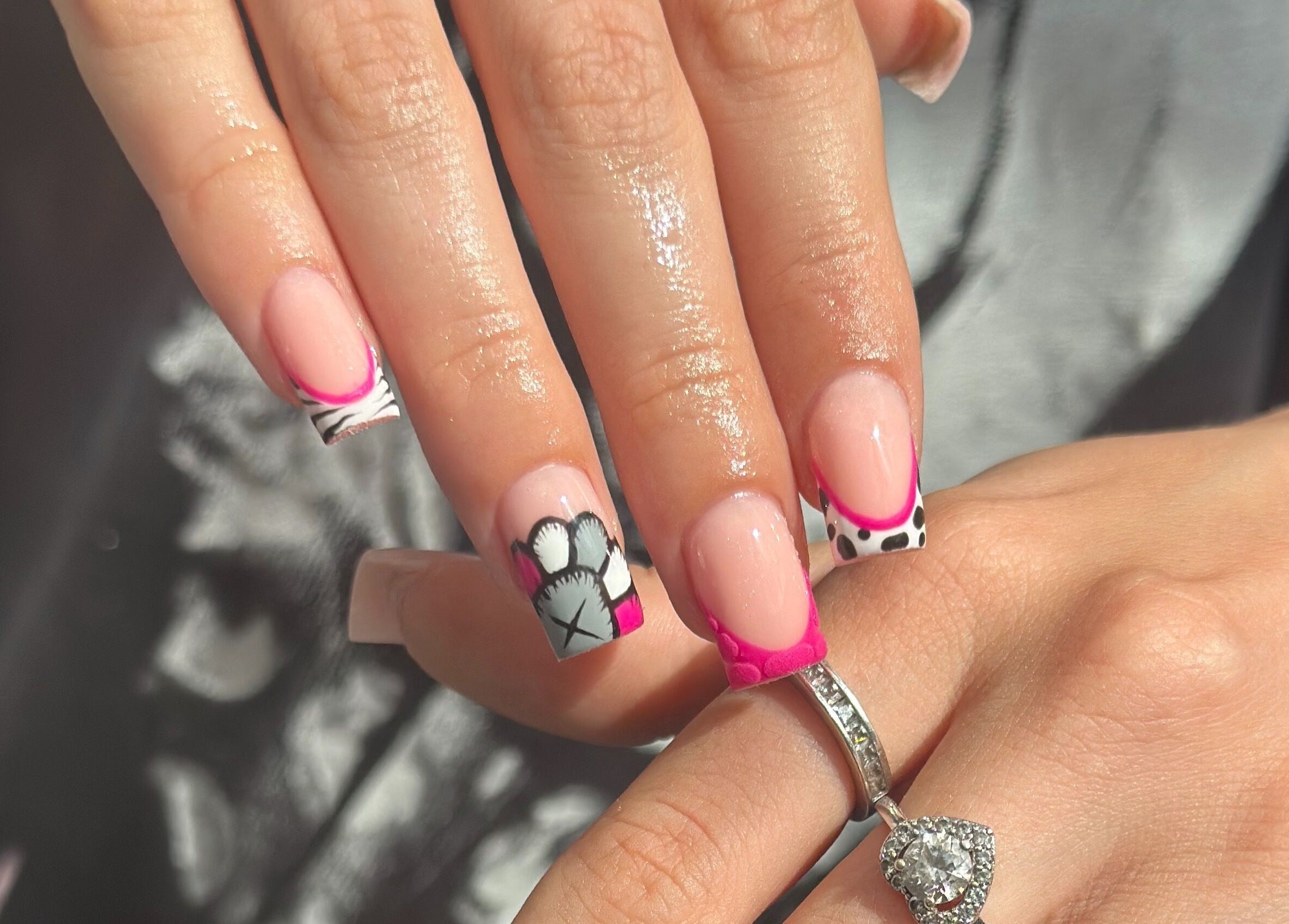 Elegant nail art with pink tips and black designs at Venus Studios, Kirkby In Ashfield, England, GB.