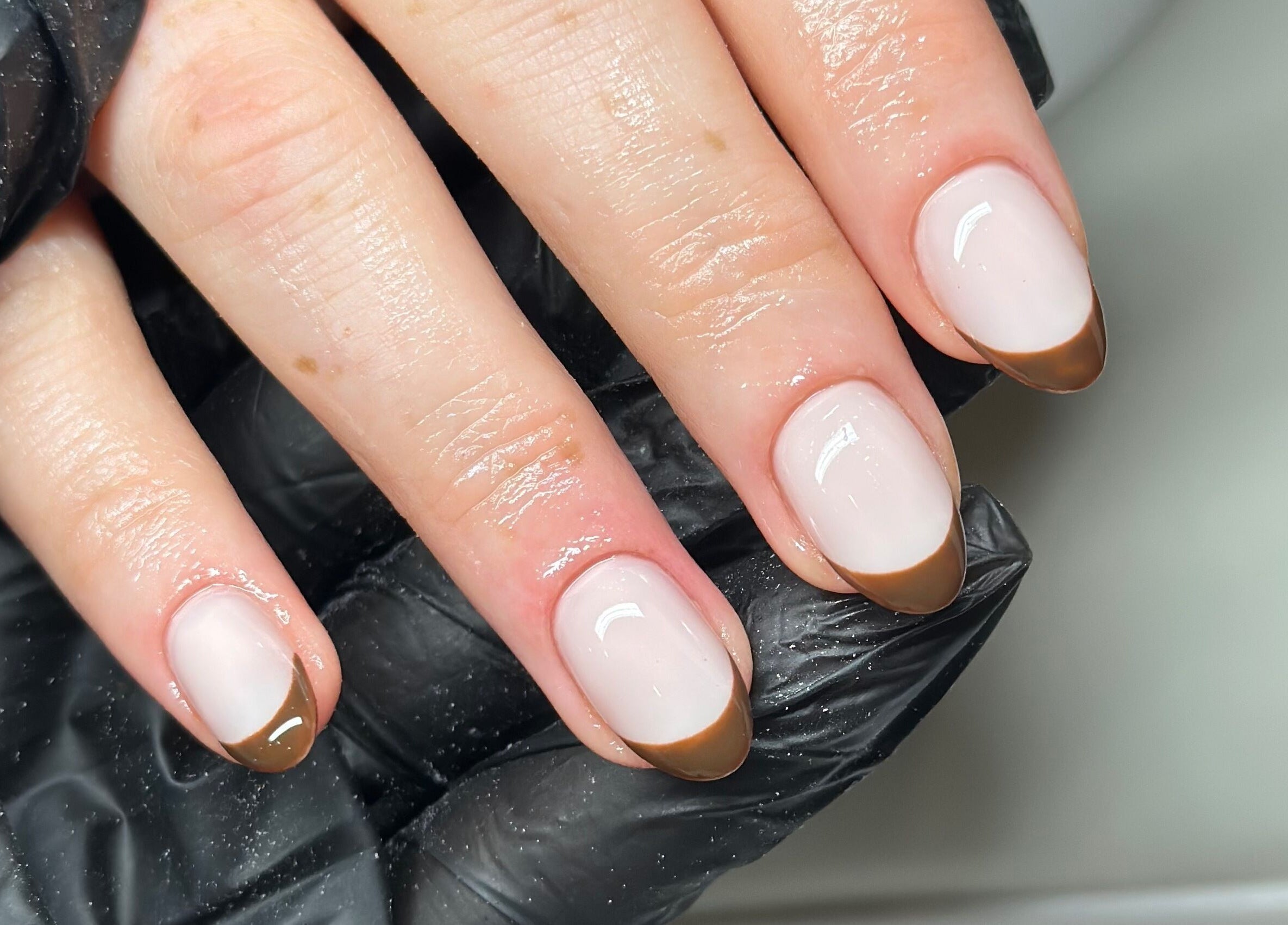 Elegant French manicure with brown tips at Venus Studios, Kirkby In Ashfield, England, GB.