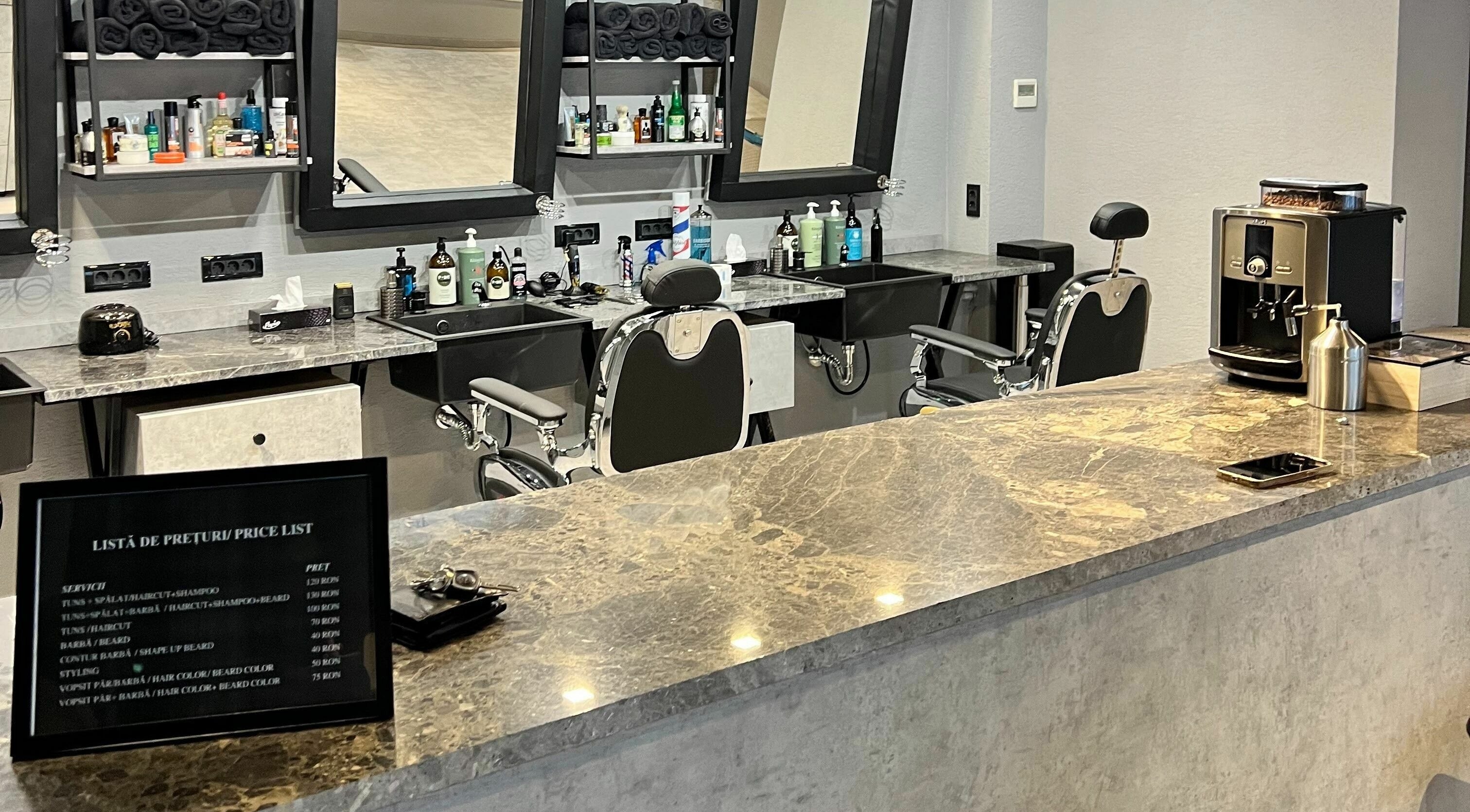 Interior modern al The Premium Barbers Dorobanti, București, București, RO, cu scaune elegante și counter marcat.