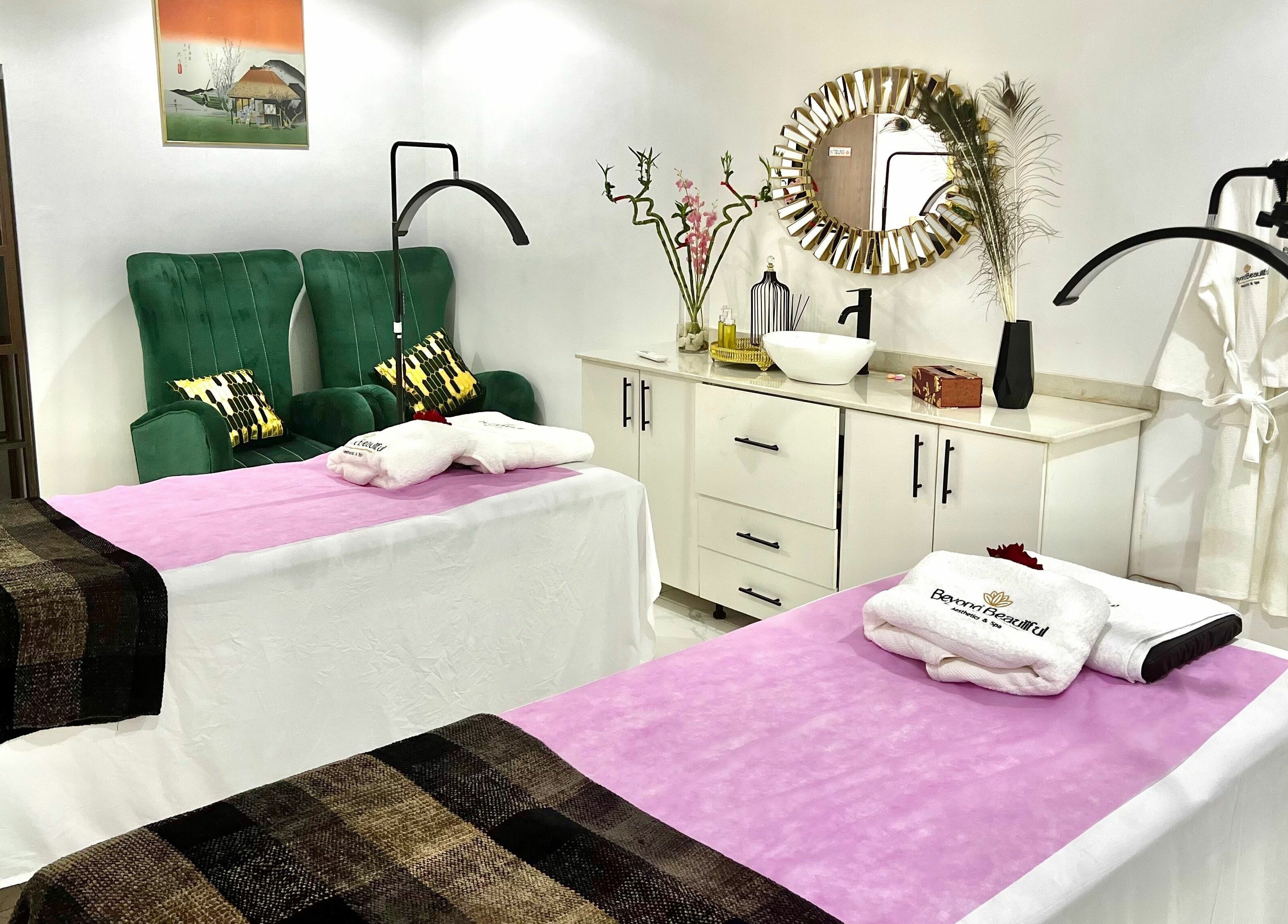 Relaxing massage room at Beyond Beautiful - Aesthetics & Spa, Abuja, Nigeria with plush chairs and decor.