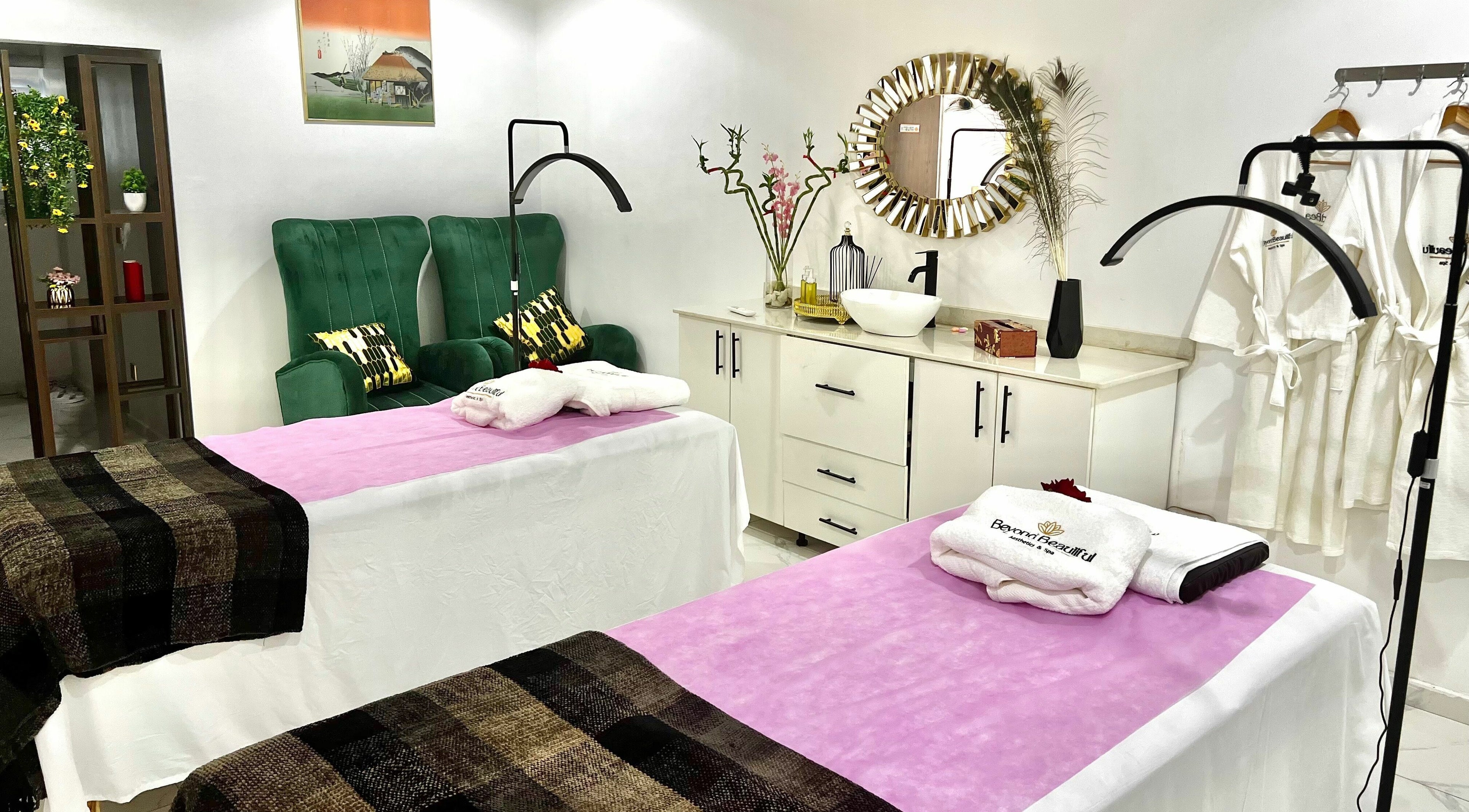 Relaxing massage room at Beyond Beautiful - Aesthetics & Spa, Abuja, Nigeria with plush chairs and decor.