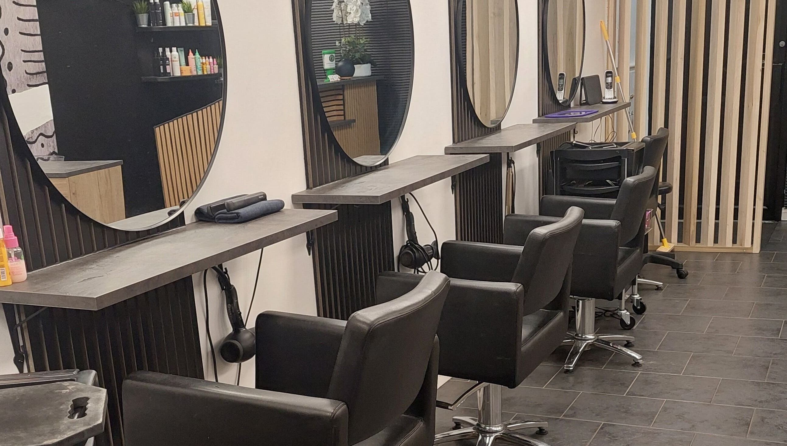 Modern hair styling area at Salon19 Coleraine, Coleraine, Northern Ireland, GB with sleek chairs and mirrors.