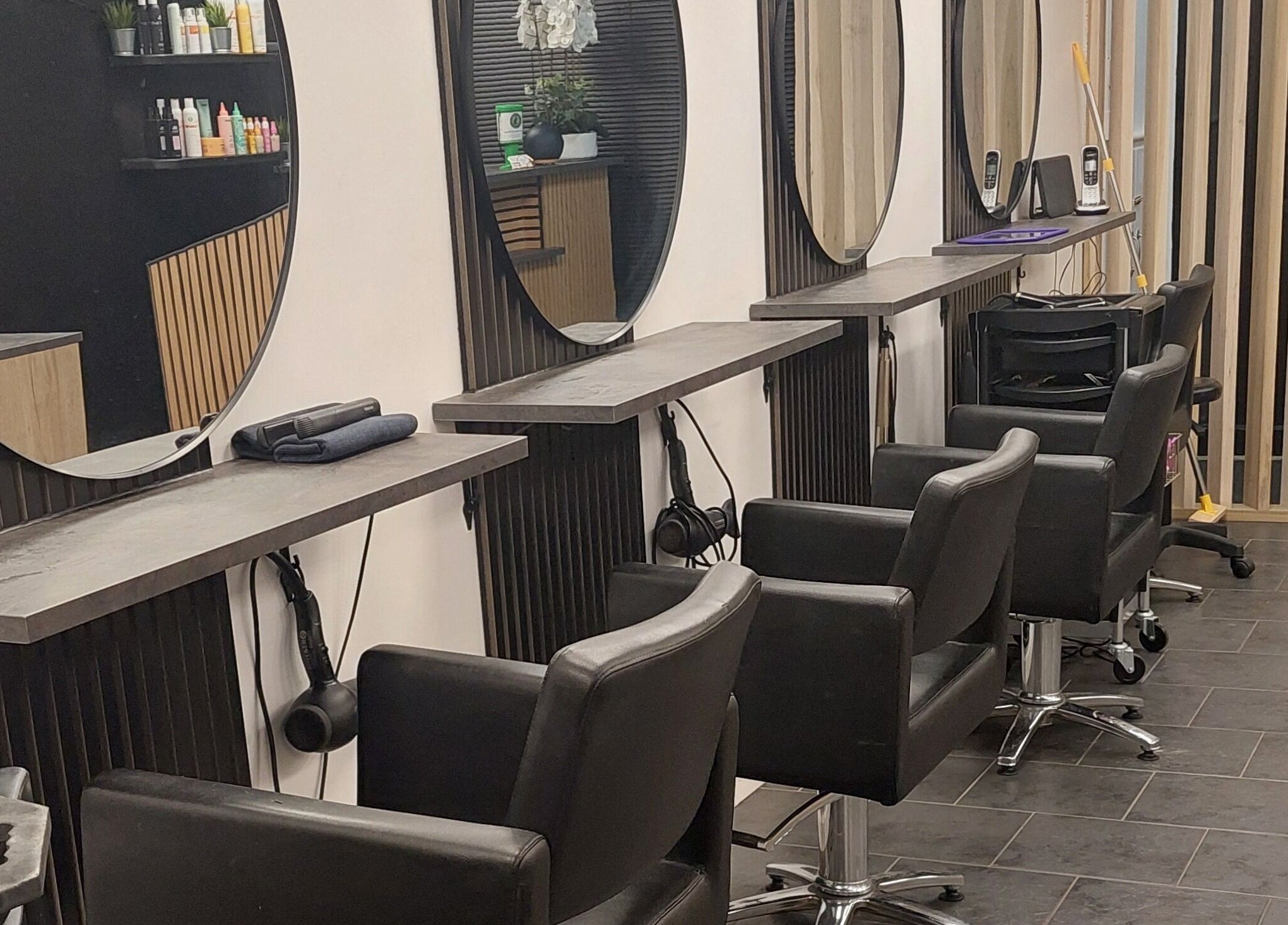 Modern hair styling area at Salon19 Coleraine, Coleraine, Northern Ireland, GB with sleek chairs and mirrors.
