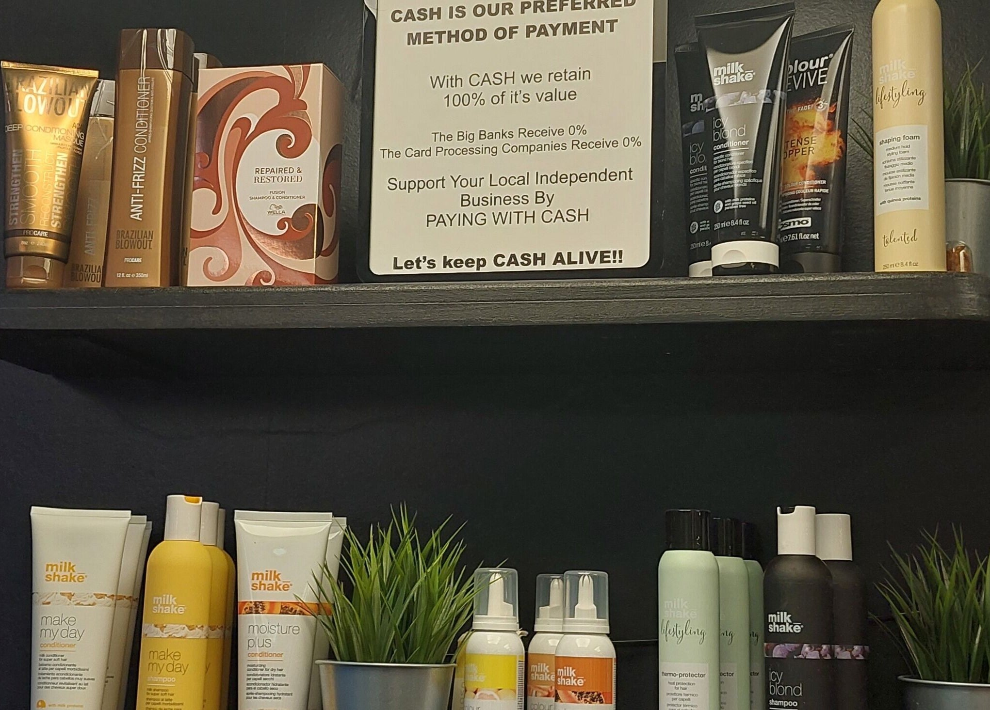 Haircare products on display shelf in Salon19 Coleraine, Northern Ireland, GB, showcasing premium brands.