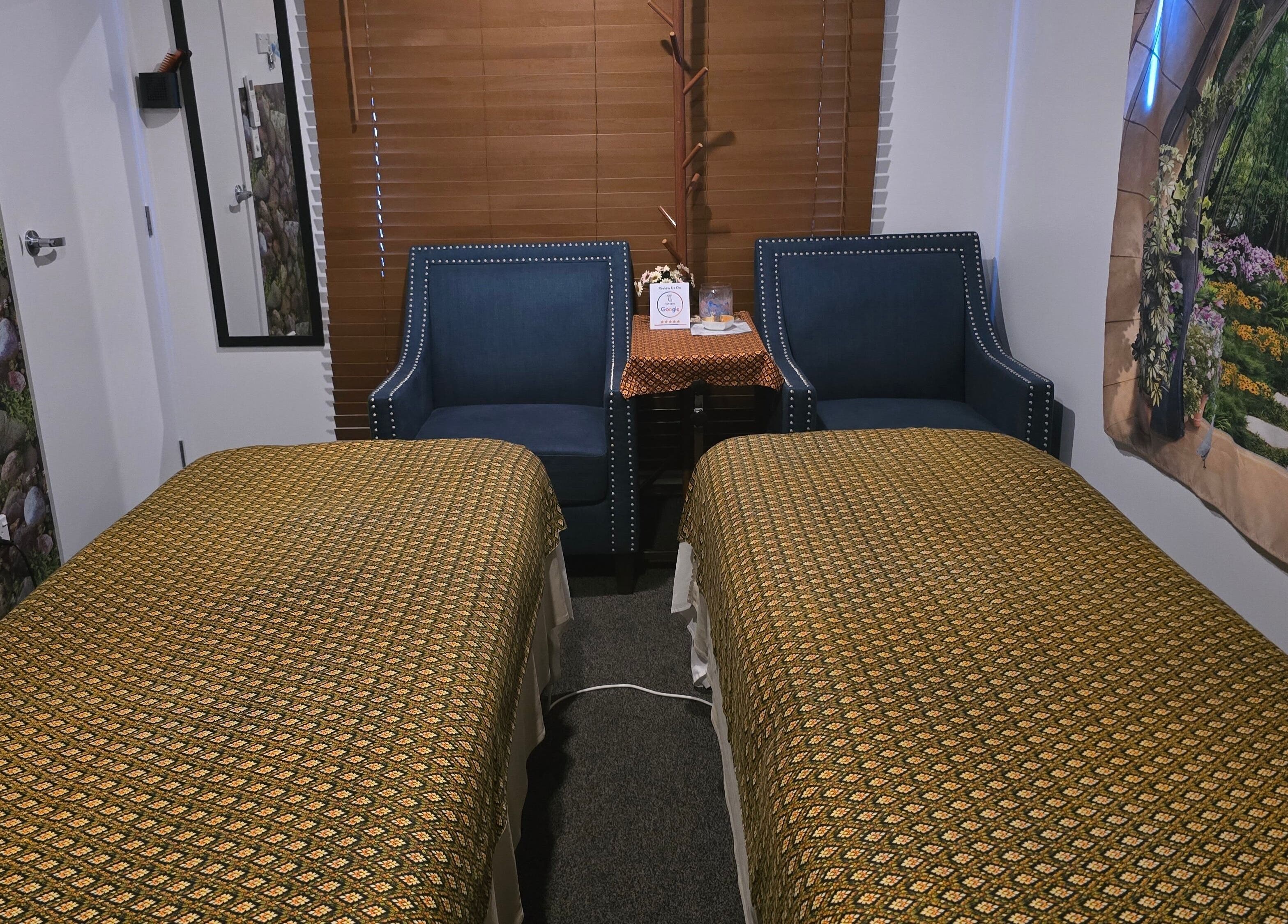 Cozy massage room at Sawasdee Massage, Christchurch, Canterbury, NZ, featuring twin beds and elegant decor.
