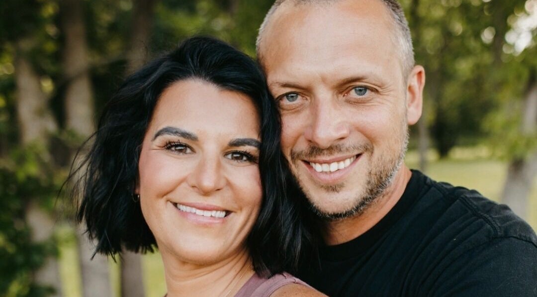 Smiling couple at Blair Derry Salon, Waverly, Minnesota, US, in a lush outdoor setting.
