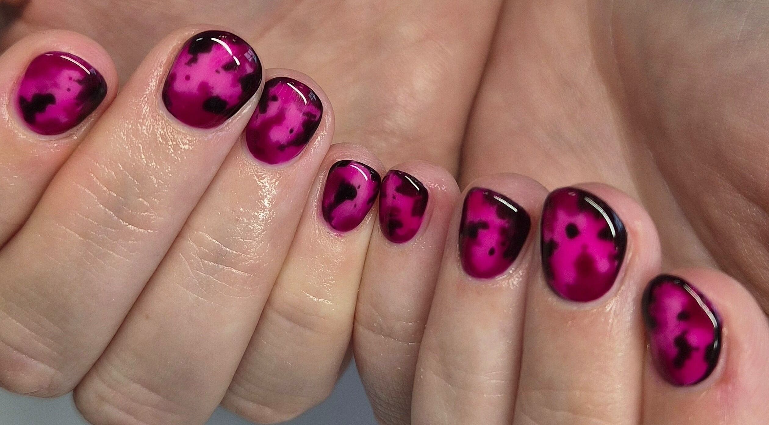 Bright magenta nail art at Art Thou Nails, Manchester, England, GB, showcasing creative design style.