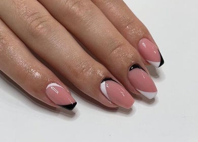 Elegant French manicure at I AM Beauty Bedford, Kempston, England, GB, showcasing glossy pink and black tip nails.