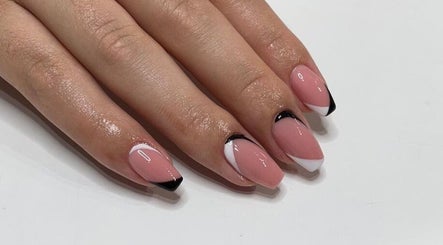 Elegant French manicure at I AM Beauty Bedford, Kempston, England, GB, showcasing glossy pink and black tip nails.