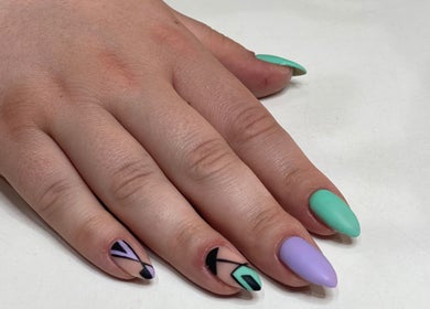 Colorful geometric nail art at I AM Beauty Bedford in Kempston, England, GB. Vibrant and modern design.