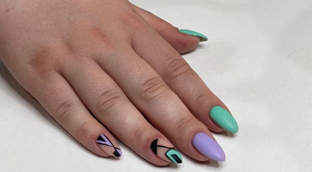 Colorful geometric nail art at I AM Beauty Bedford in Kempston, England, GB. Vibrant and modern design.