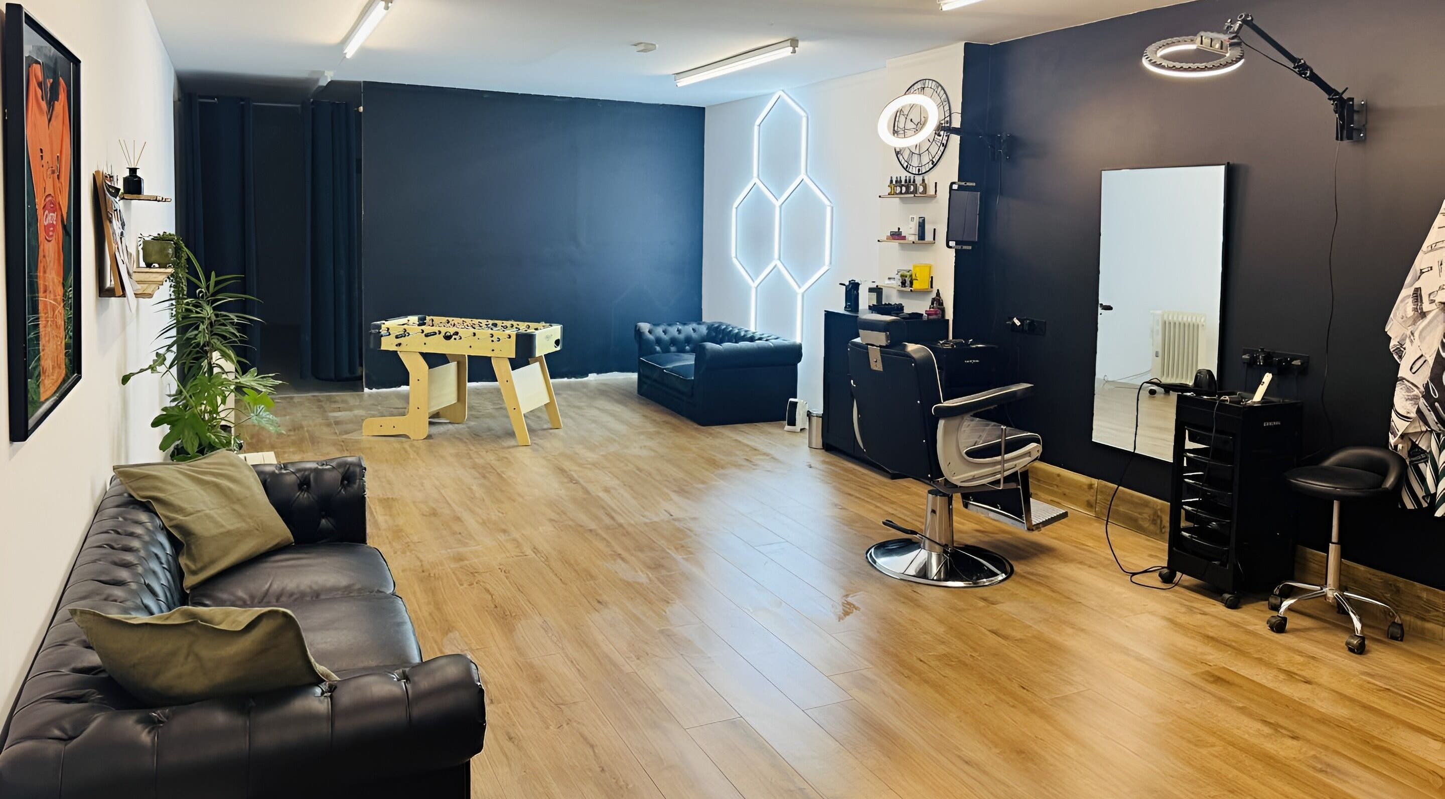 Modern interior of Chris Brown - The Barber in Plymouth, England, GB, featuring leather seating and styling stations.