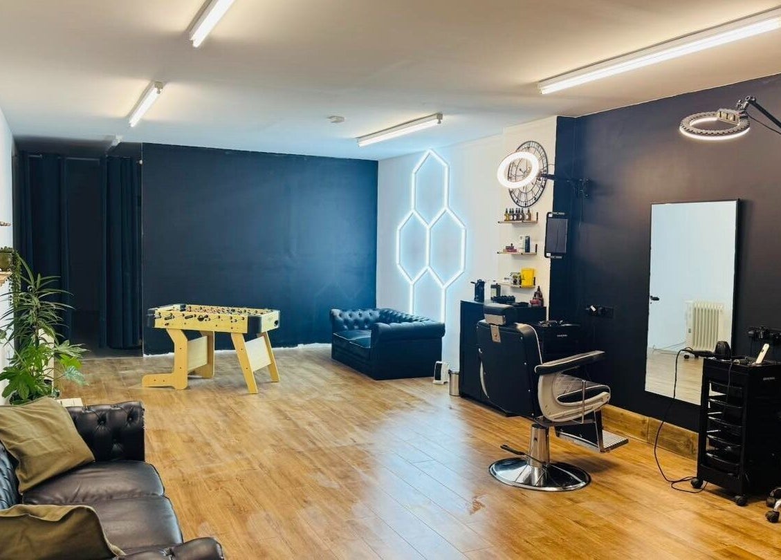Modern interior of Chris Brown - The Barber in Plymouth, England, GB with leather seating and stylish decor.