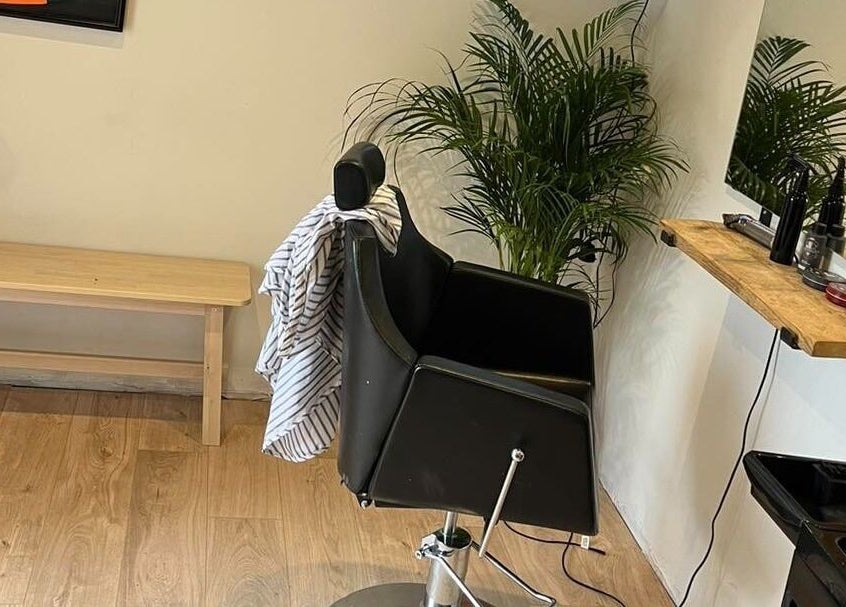 Stylish barber chair at Chris Brown - The Barber in Plymouth, England, GB, with a sleek design and cozy ambiance.