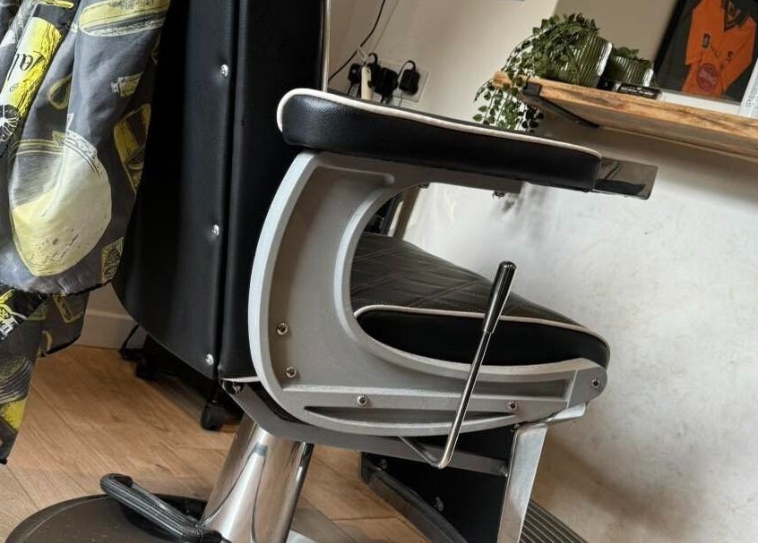 Elegant barber chair at Chris Brown - The Barber, Plymouth, England, GB, showcasing premium styling setup.