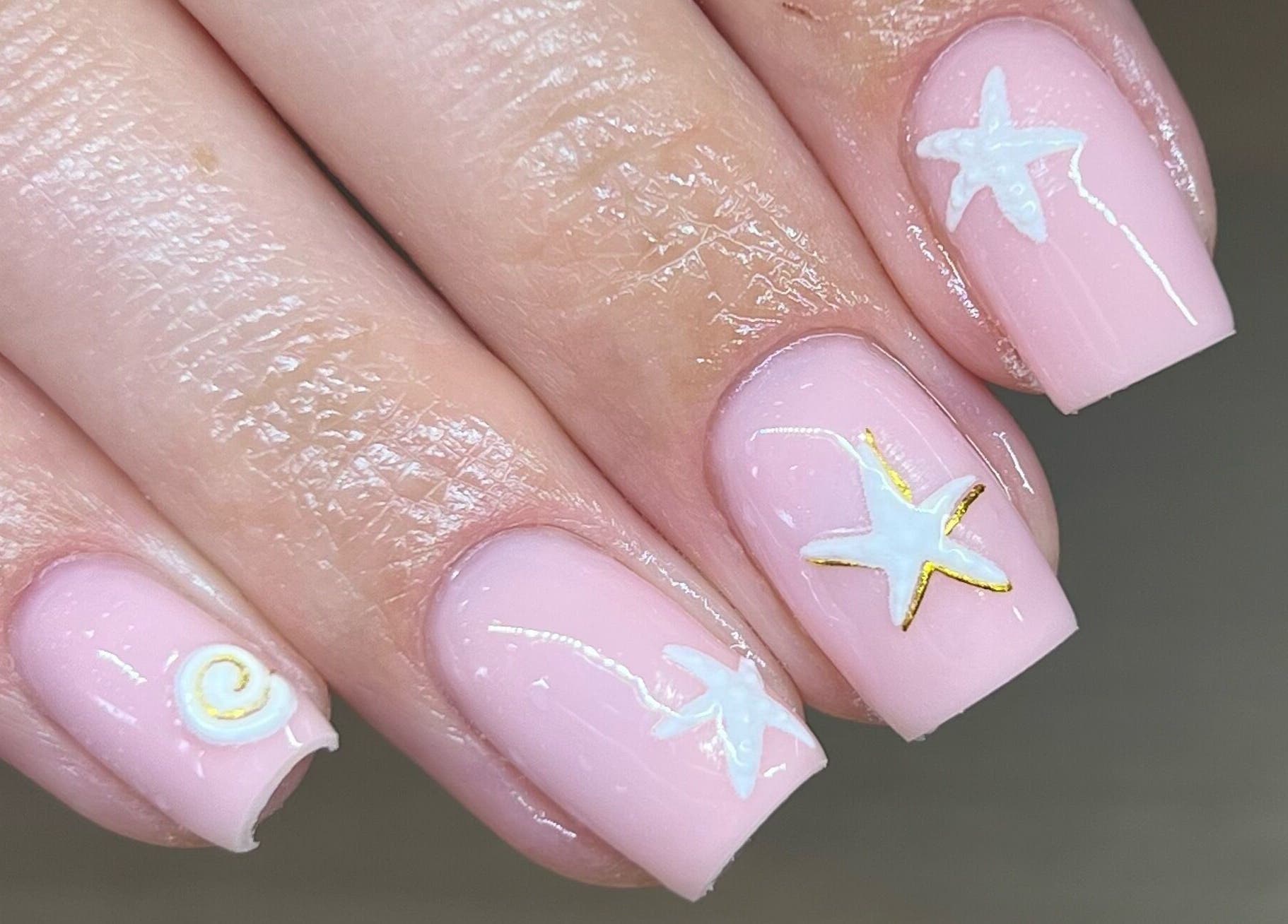Pastel pink nails with starfish design at Beauty by Lydia, Burton Upon Trent, England, GB.