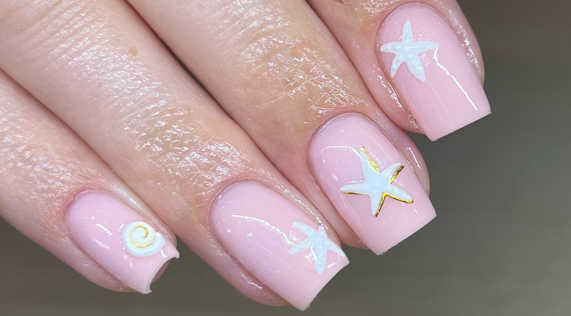 Pastel pink nails with starfish design at Beauty by Lydia, Burton Upon Trent, England, GB.