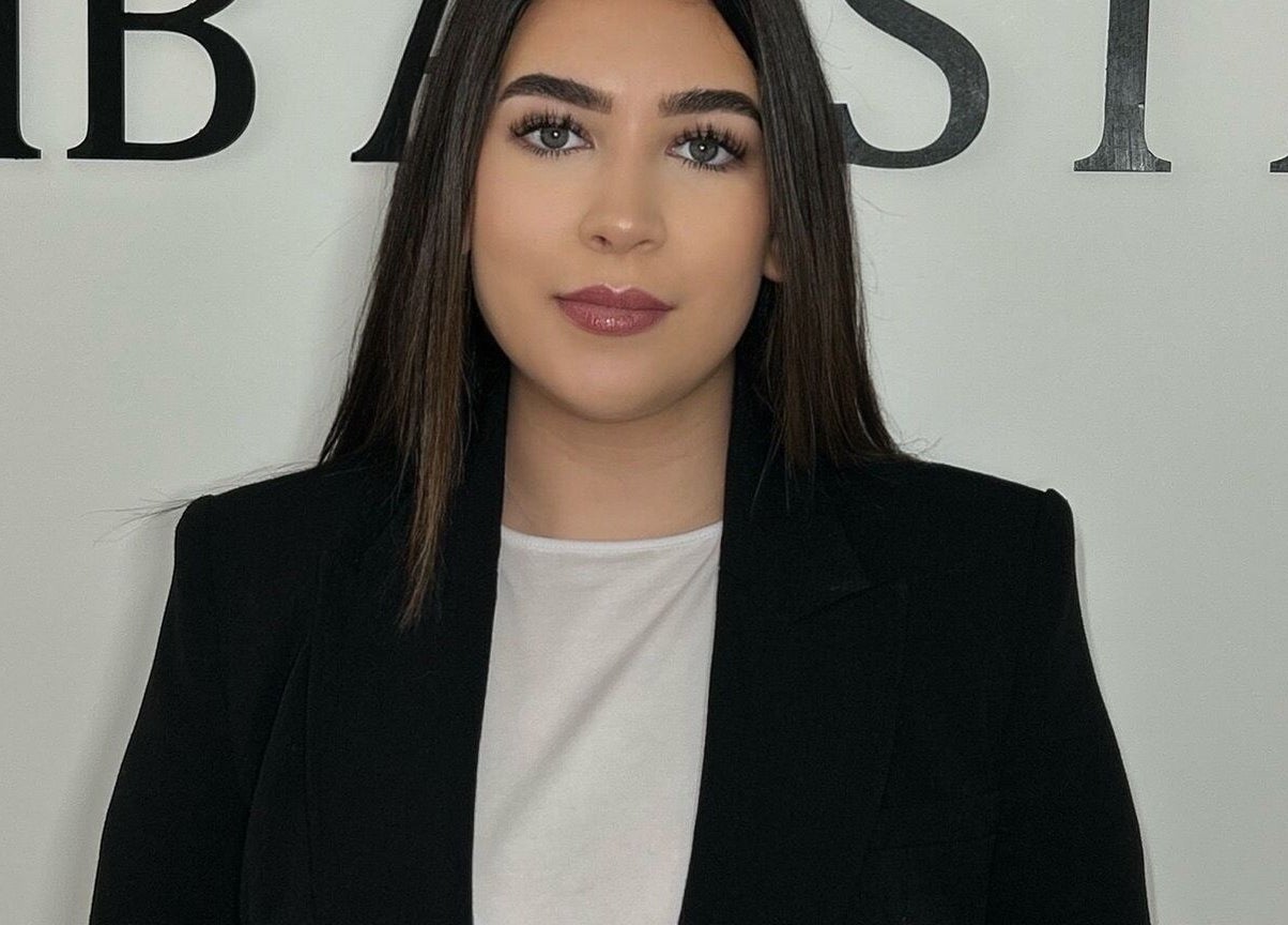 Professional staff member at HB Aesthetics, Cannock, England, GB welcomes clients with a warm smile.