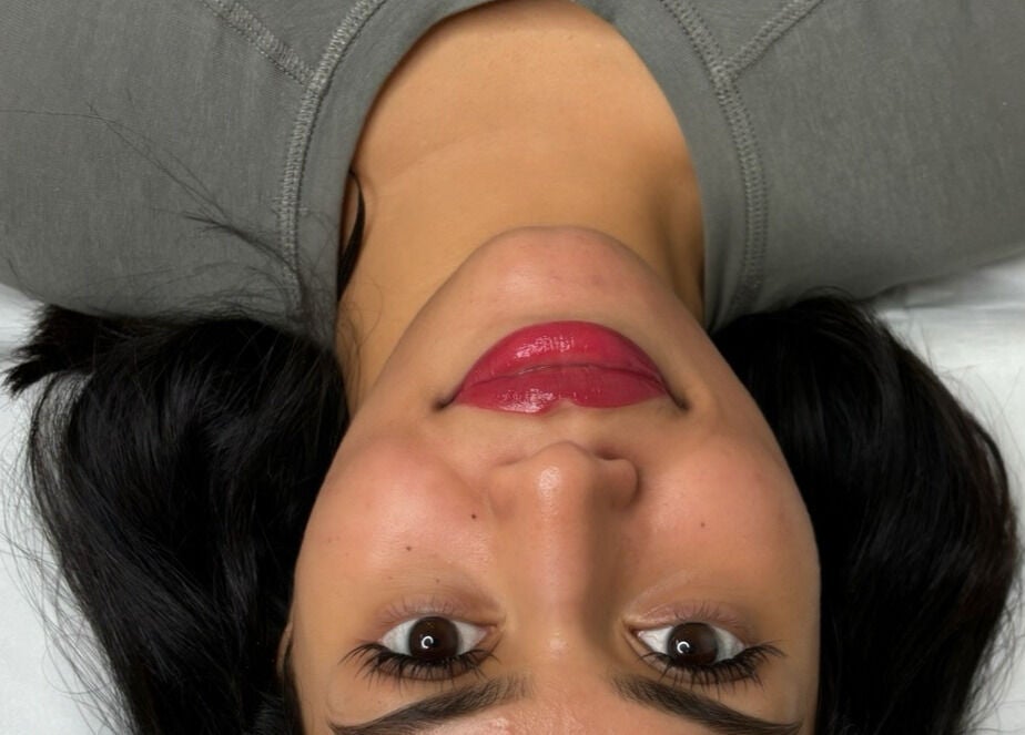 A client enjoying a beauty treatment at HB Aesthetics, Cannock, England, GB with a relaxed and radiant smile.