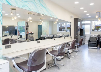 Modern interior of Salon 24 Hadley Wood in Barnet, England, GB with stylish chairs and wash stations.