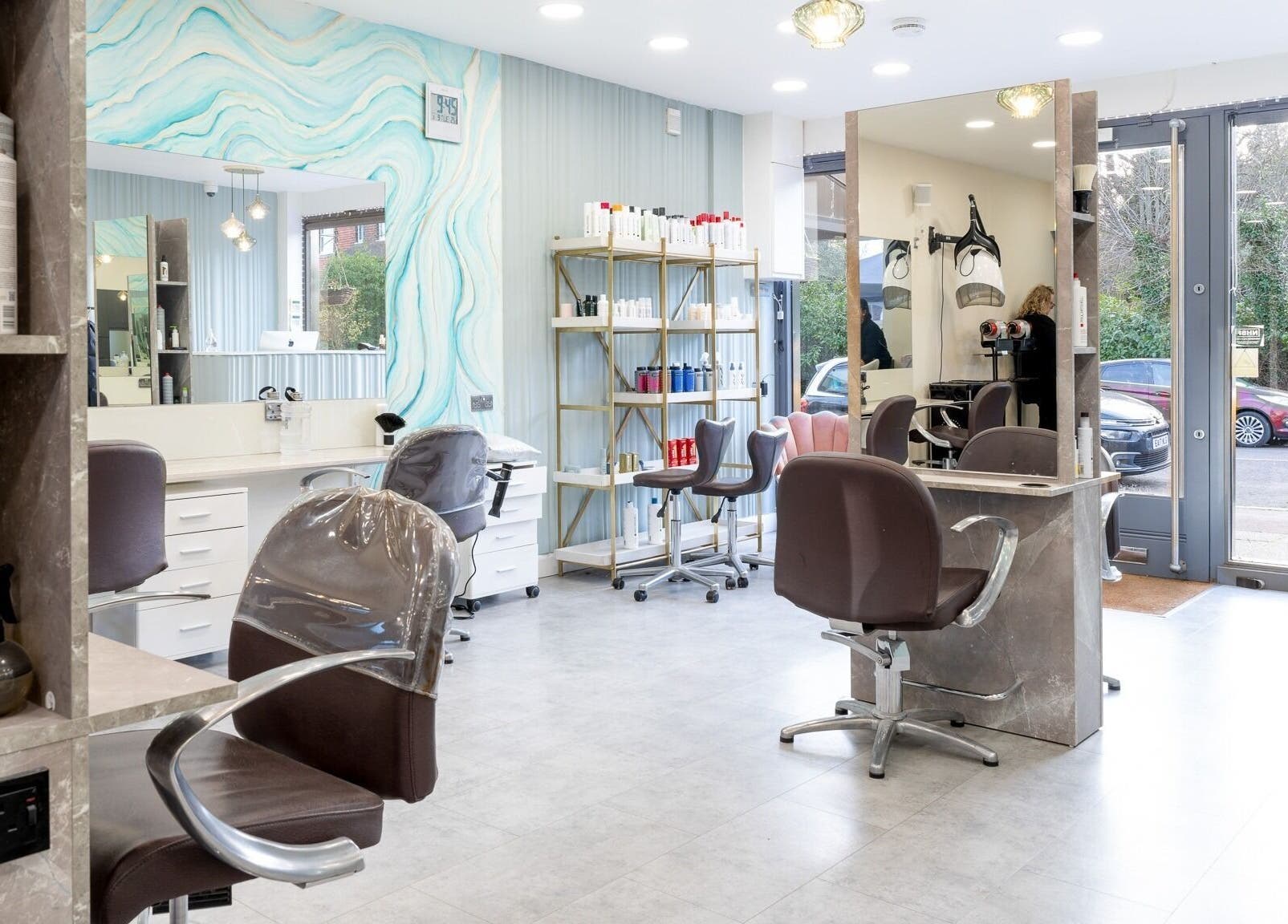 Modern interior of Salon 24 Hadley Wood in Barnet, England, GB featuring styling stations and luxury products.