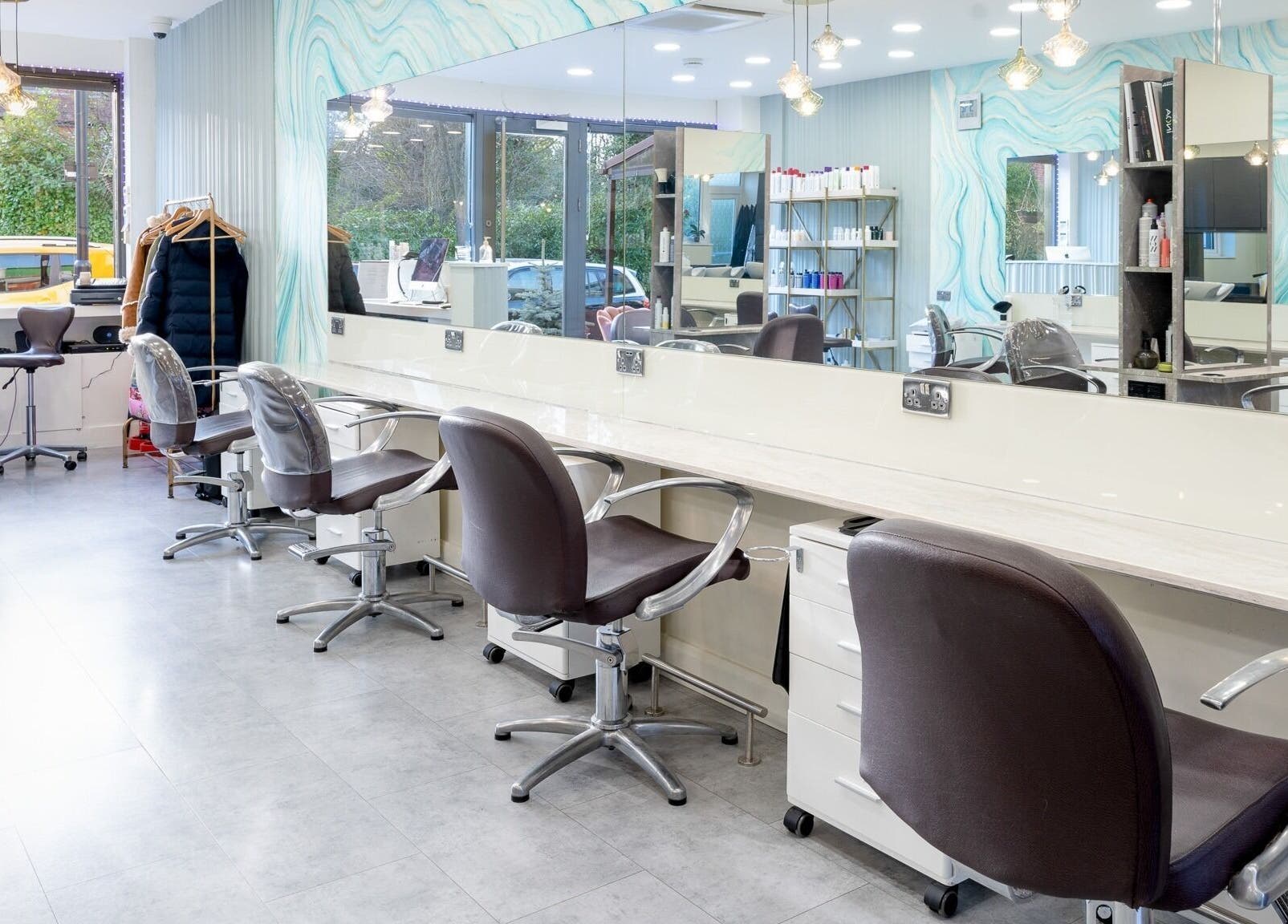 Modern salon chairs and mirrors at Salon 24 Hadley Wood, Barnet, England, GB, showcasing stylish ambiance.