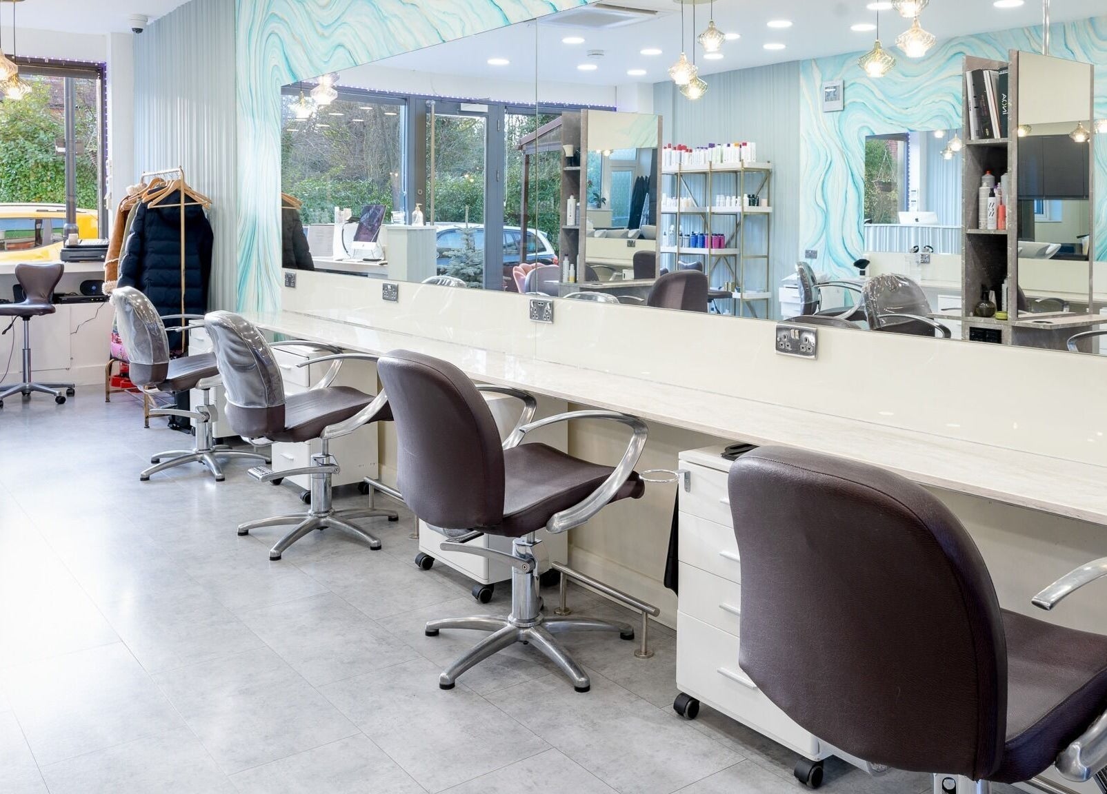 Modern salon chairs and mirrors at Salon 24 Hadley Wood, Barnet, England, GB, showcasing stylish ambiance.