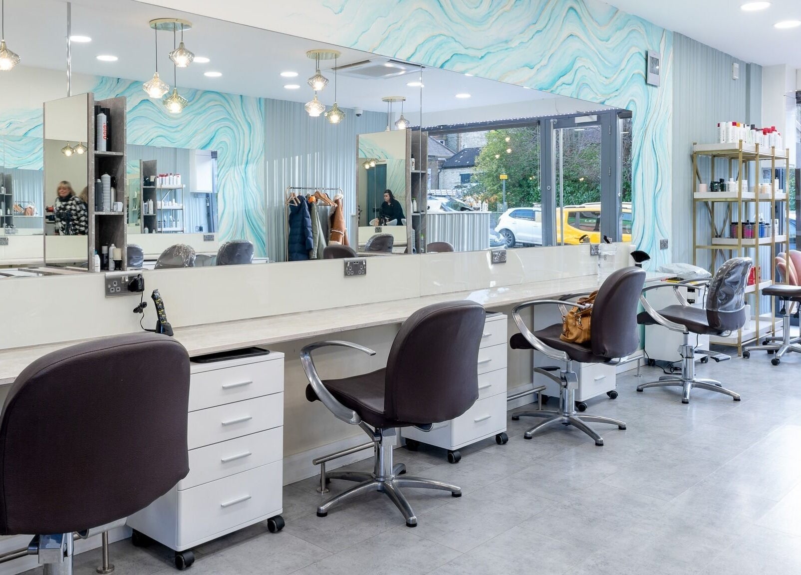 Modern salon interior of Salon 24 Hadley Wood, Barnet, England, GB with stylish chairs and mirrors.