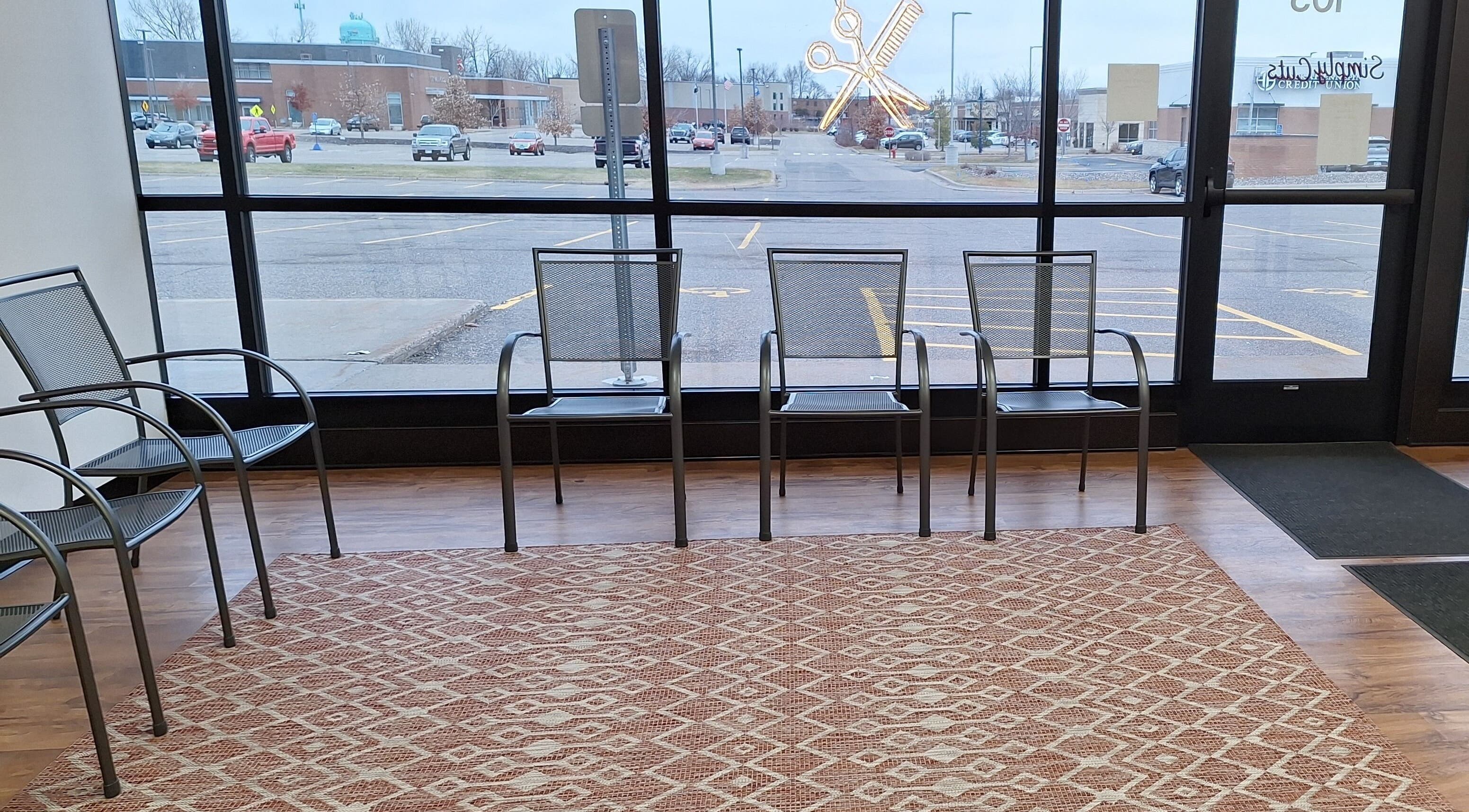 Simply Cuts waiting area with modern chairs in Forest Lake, Minnesota, US.