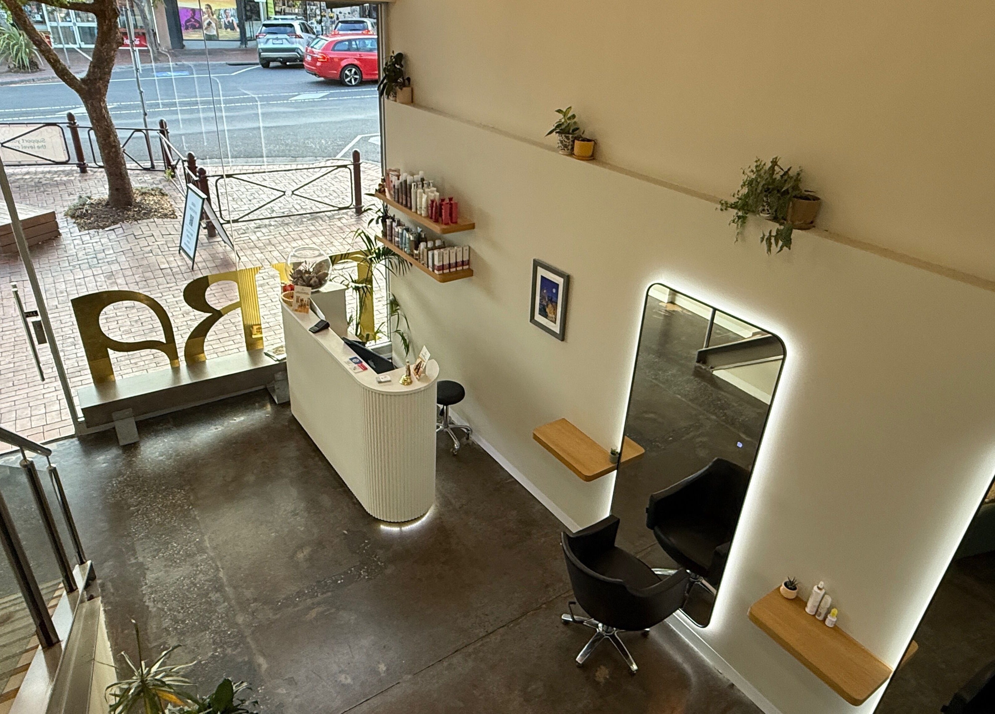 Modern interior of Biba Croydon salon in Melbourne, Victoria, AU, featuring stylish mirrors and seating.