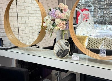 Elegant beauty station at Spy Salon - North Circular Rd, Dublin, IE with floral decor and circular mirrors.