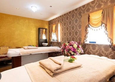 Relaxing treatment room at Spy Salon Nutgrove - Rathfarnham, Dublin, County Dublin, IE with plush decor and flowers.