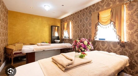 Relaxing treatment room at Spy Salon Nutgrove - Rathfarnham, Dublin, County Dublin, IE with plush decor and flowers.