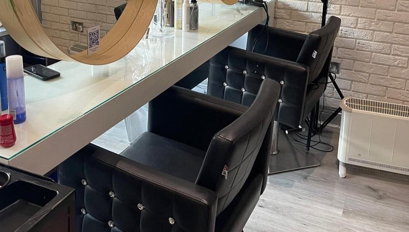 Chic styling area in Spy Salon - North Circular Rd, Dublin, County Dublin, IE with modern chairs and mirrors.
