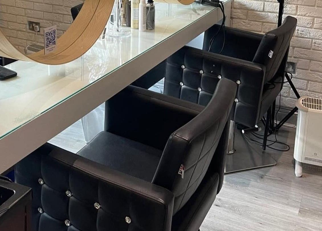 Chic styling area in Spy Salon - North Circular Rd, Dublin, County Dublin, IE with modern chairs and mirrors.