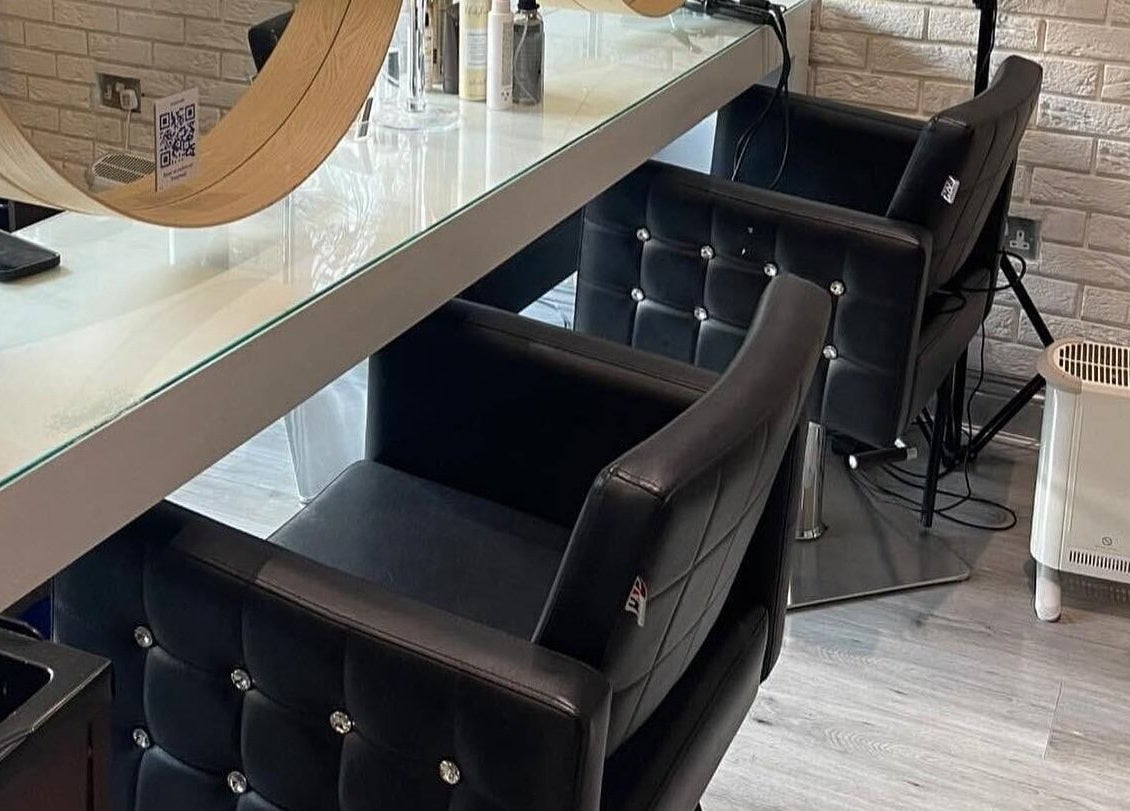 Chic styling area in Spy Salon - North Circular Rd, Dublin, County Dublin, IE with modern chairs and mirrors.