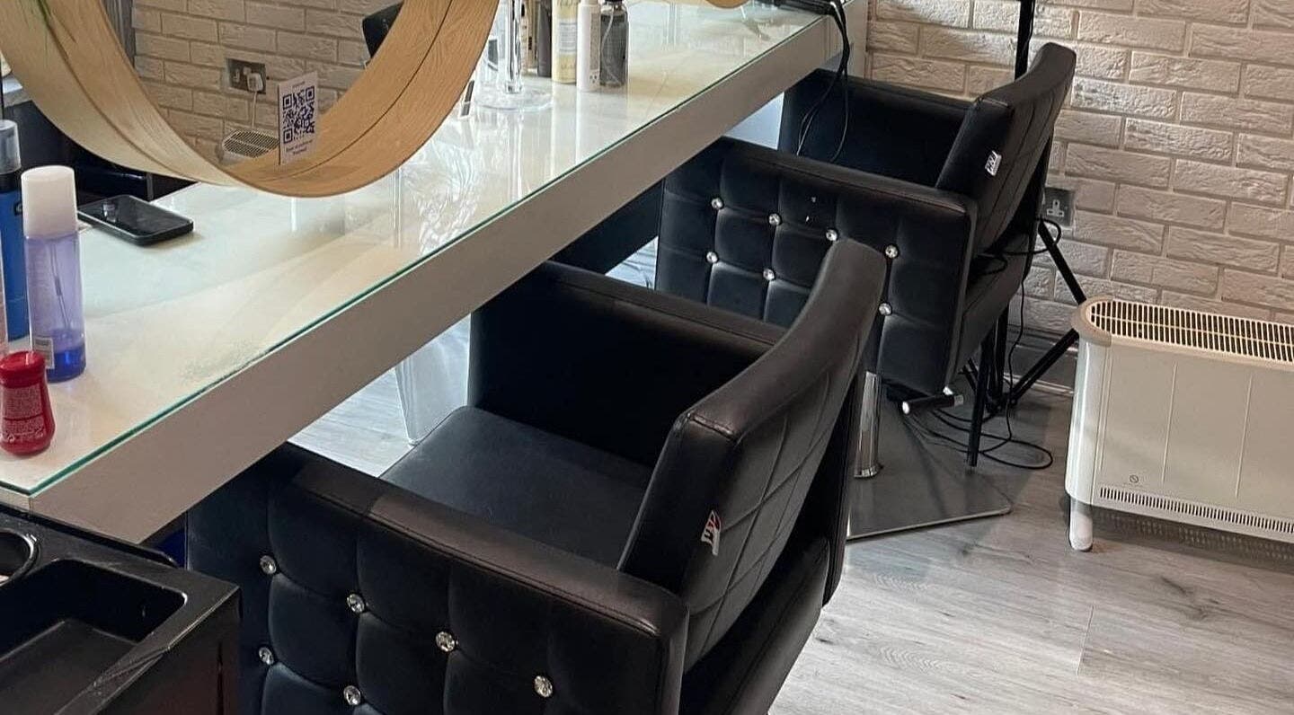 Chic styling area in Spy Salon - North Circular Rd, Dublin, County Dublin, IE with modern chairs and mirrors.