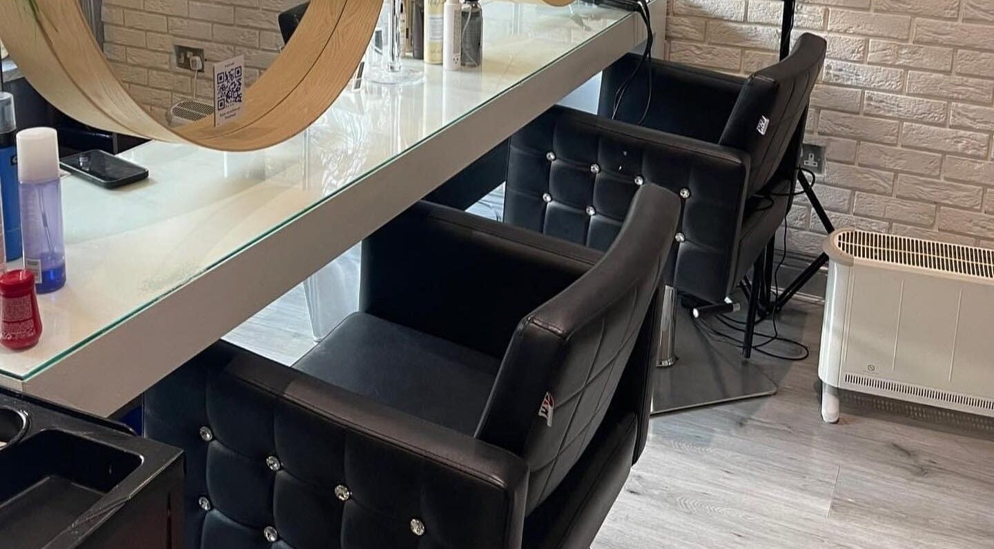 Chic styling area in Spy Salon - North Circular Rd, Dublin, County Dublin, IE with modern chairs and mirrors.