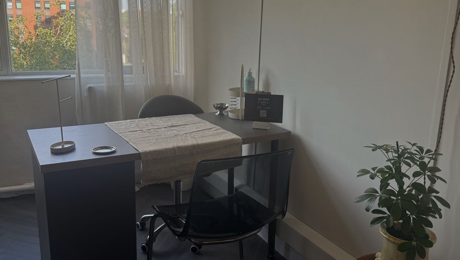 Cozy nail station at Port Studio, Stockport, England with natural light and greenery.