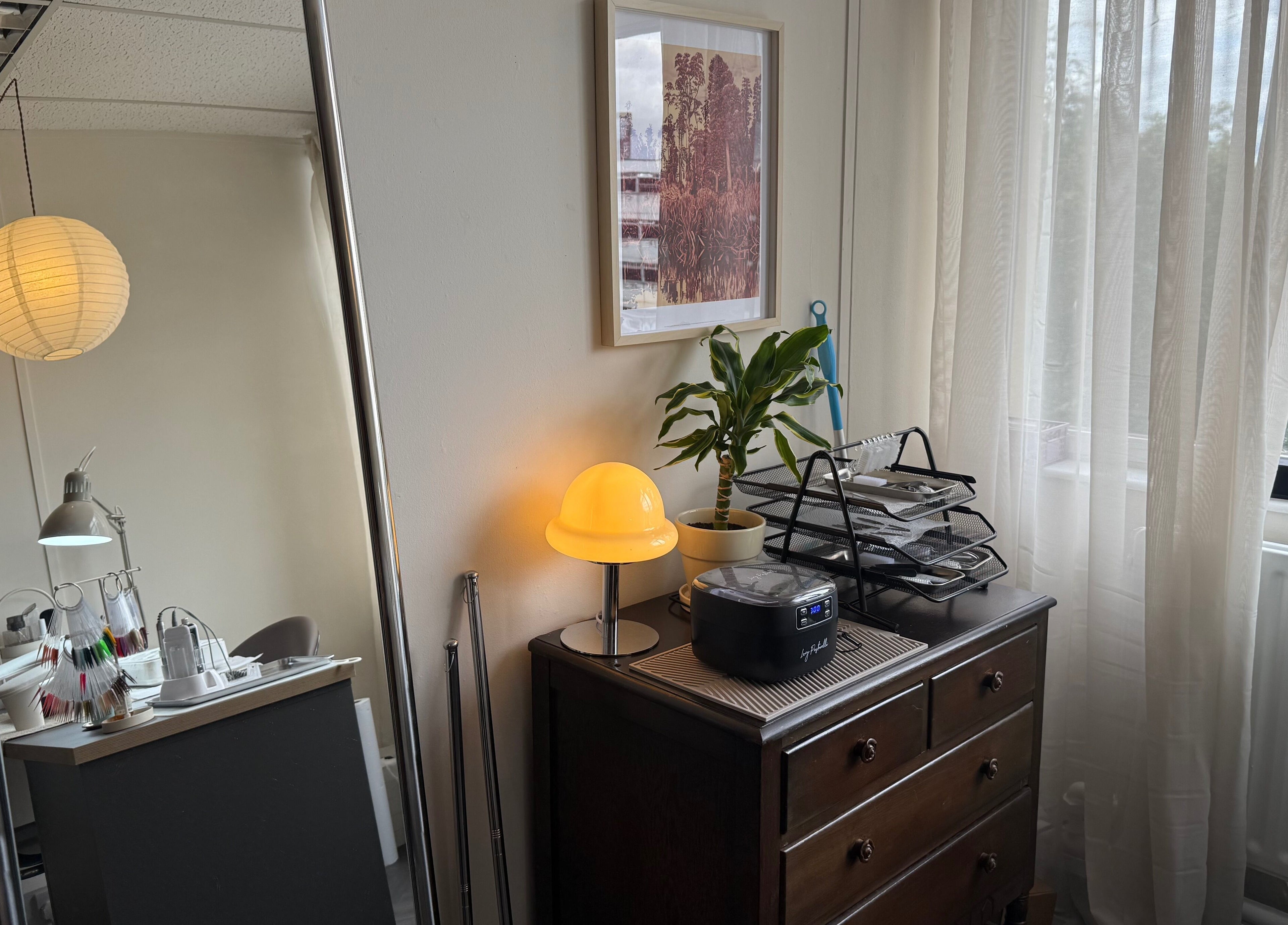 Cozy interior at Port Studio, Stockport, England, with plants, desk, and soft lighting creating a serene atmosphere.