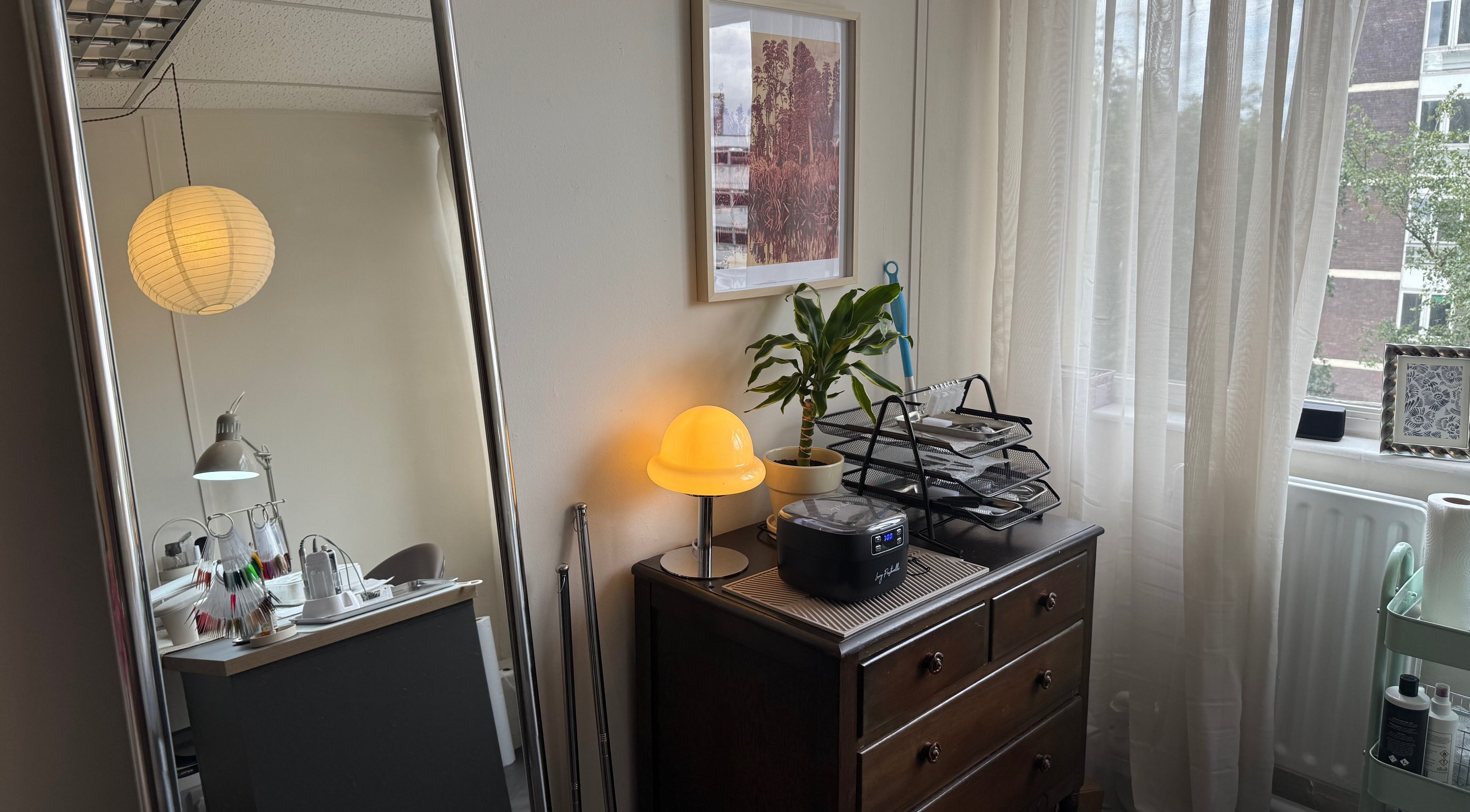 Cozy interior at Port Studio, Stockport, England, with plants, desk, and soft lighting creating a serene atmosphere.