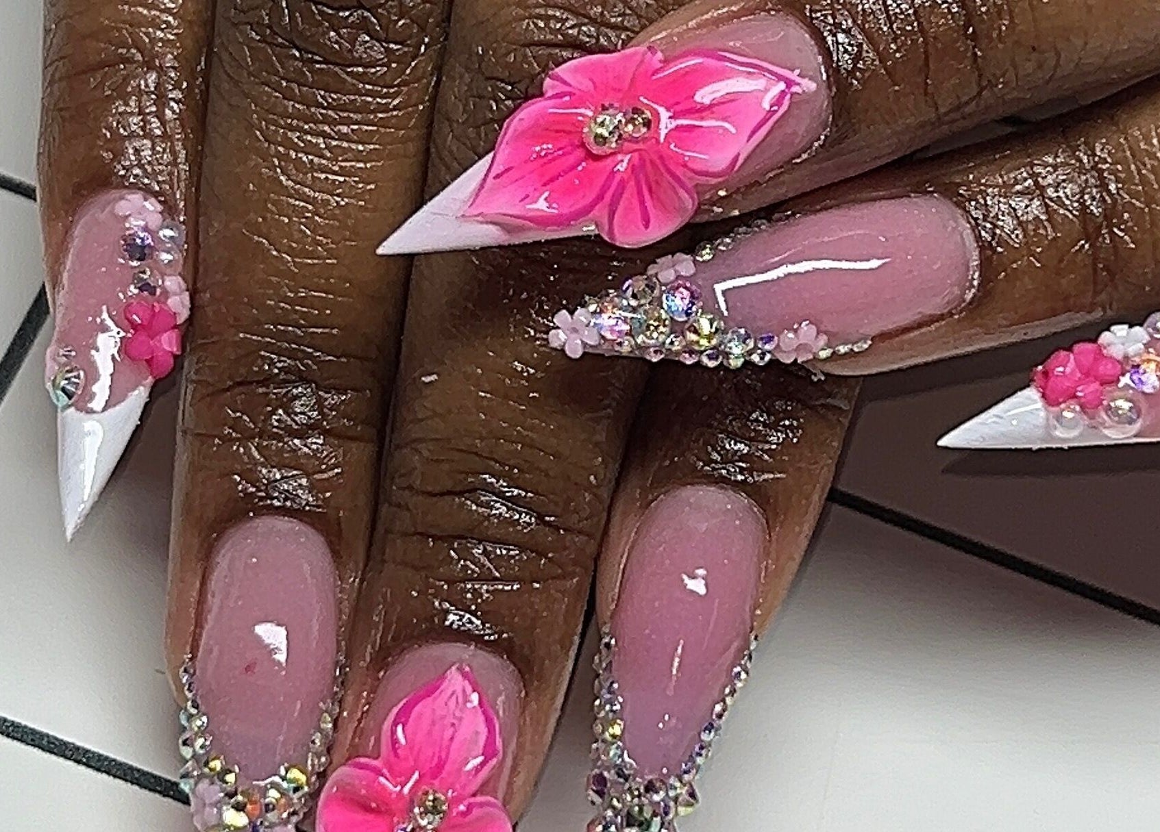 Detailed pink floral nail art at Rx Nailz, Brampton, Ontario, CA showcasing elegance and craftsmanship.